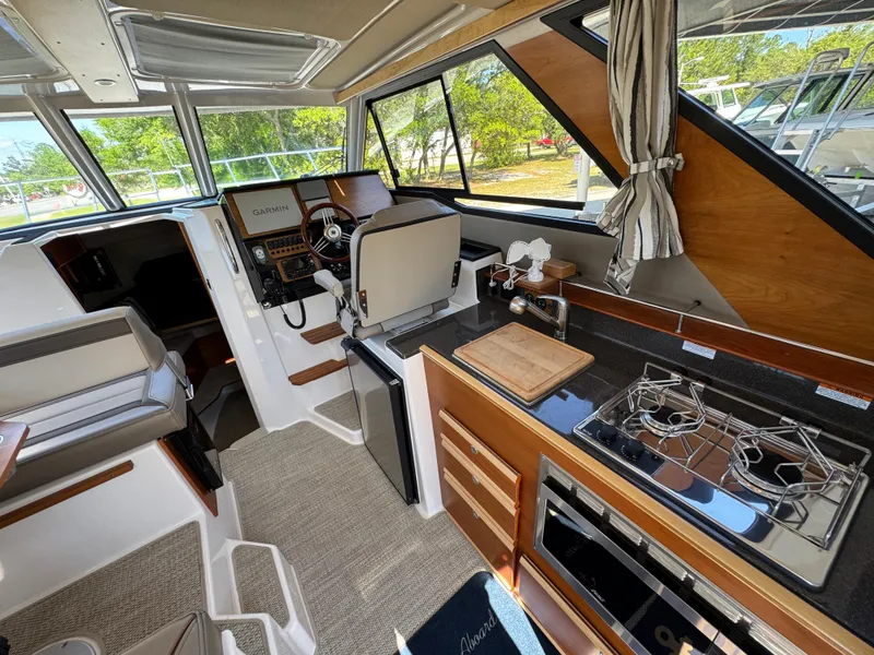 Slide: The Image of 2024 Cutwater C-288 Coupe interior with modern kitchen and navigation area. - 45