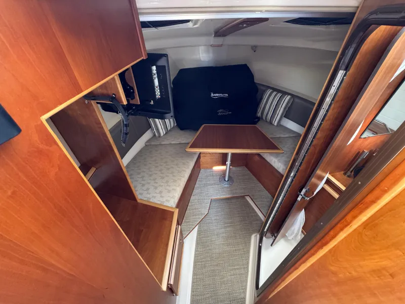 Slide: The Image of 2024 Cutwater C-288 Coupe interior with wood finish, seating, and table. - 47