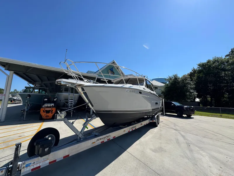 Slide: The Image of 2024 Cutwater C-288 Coupe boat on trailer under clear blue sky. - 5