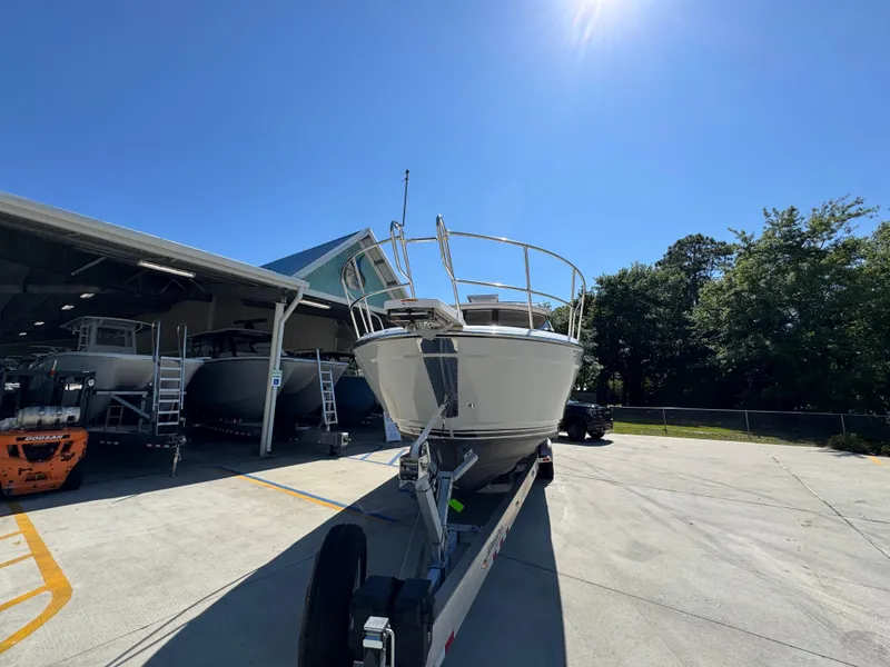 Slide: The Image of 2024 Cutwater C-288 Coupe boat on trailer under clear blue sky. - 7