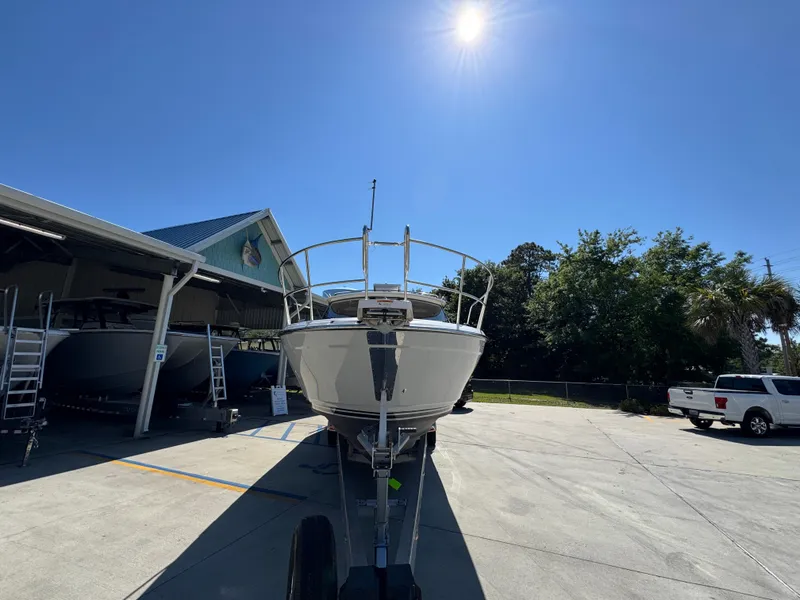 Slide: The Image of 2024 Cutwater C-288 Coupe boat on trailer under bright sun. - 8