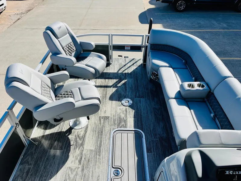 Slide: The Image of 2025 Ranger Reata 223FC boat interior with plush seating and modern design. - 12
