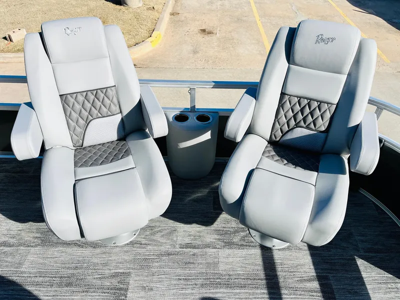 Slide: The Image of 2025 Ranger Reata 223FC boat seats with gray upholstery and diamond stitching. - 14
