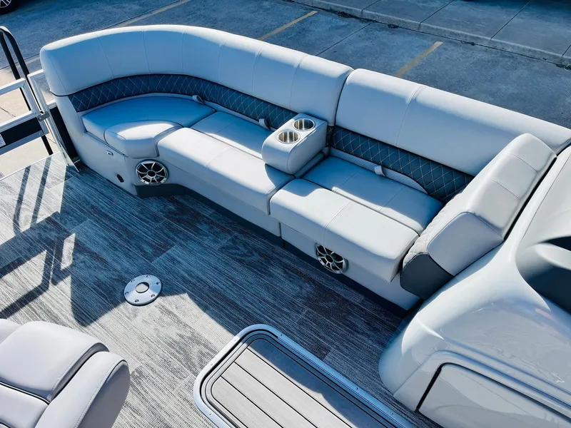Slide: The Image of 2025 Ranger Reata 223FC boat interior with plush seating and cup holders. - 16