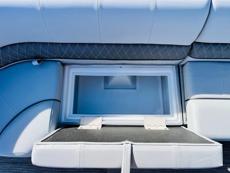 Slide: The Image of 2025 Ranger Reata 223FC boat seat with open storage compartment. - 19