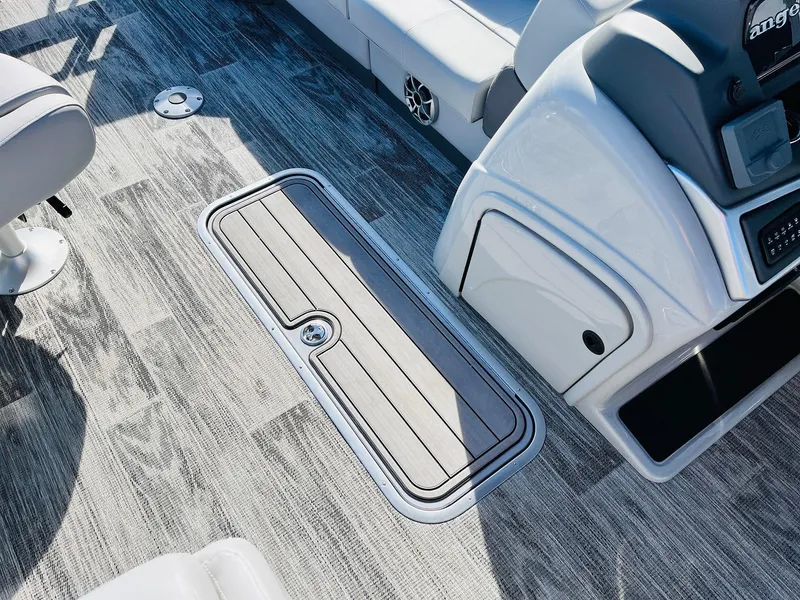 Slide: The Image of 2025 Ranger Reata 223FC boat interior with sleek flooring and storage compartment. - 21