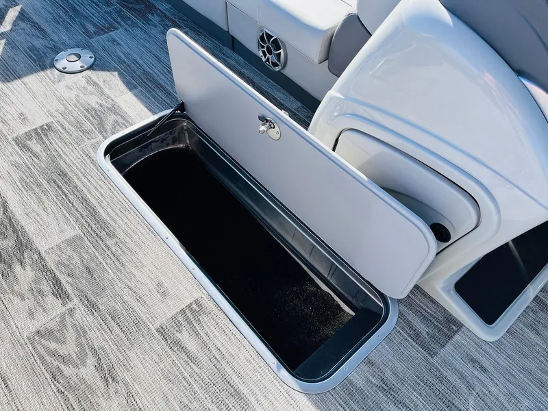 Slide: The Image of Open storage compartment on 2025 Ranger Reata 223FC boat deck. - 22