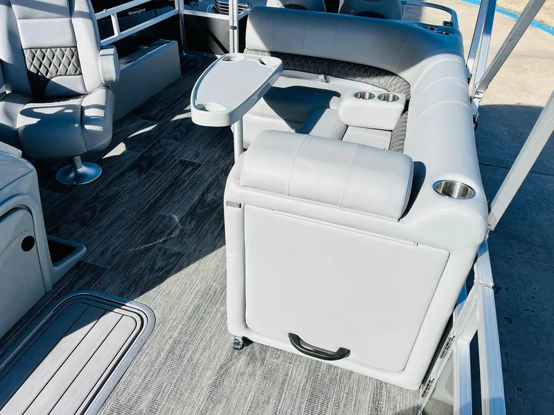 Slide: The Image of 2025 Ranger Reata 223FC boat interior with gray seating and cup holders. - 23