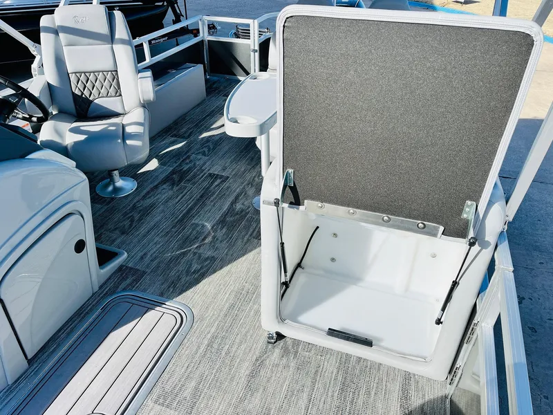Slide: The Image of 2025 Ranger Reata 223FC boat interior with seating and storage compartment. - 24