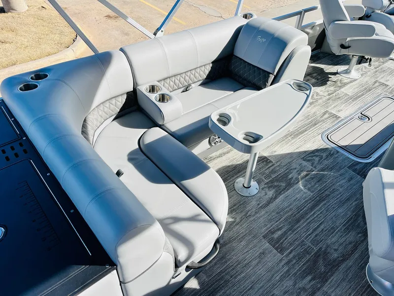 Slide: The Image of 2025 Ranger Reata 223FC boat interior with gray seating and table. - 25