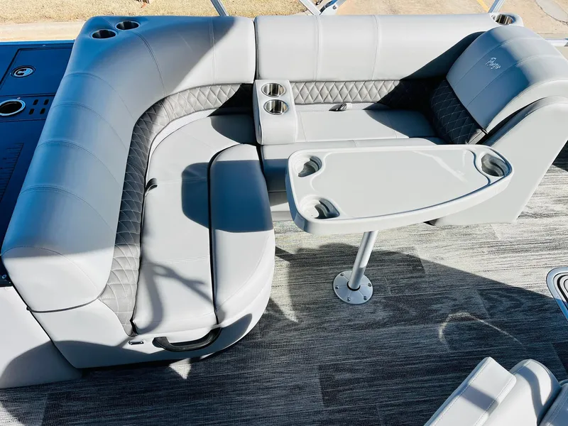 Slide: The Image of 2025 Ranger Reata 223FC boat interior with gray seating and table. - 26