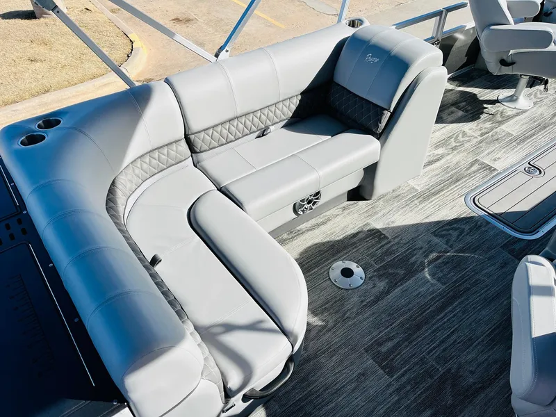 Slide: The Image of 2025 Ranger Reata 223FC boat interior with gray seating and modern design. - 27
