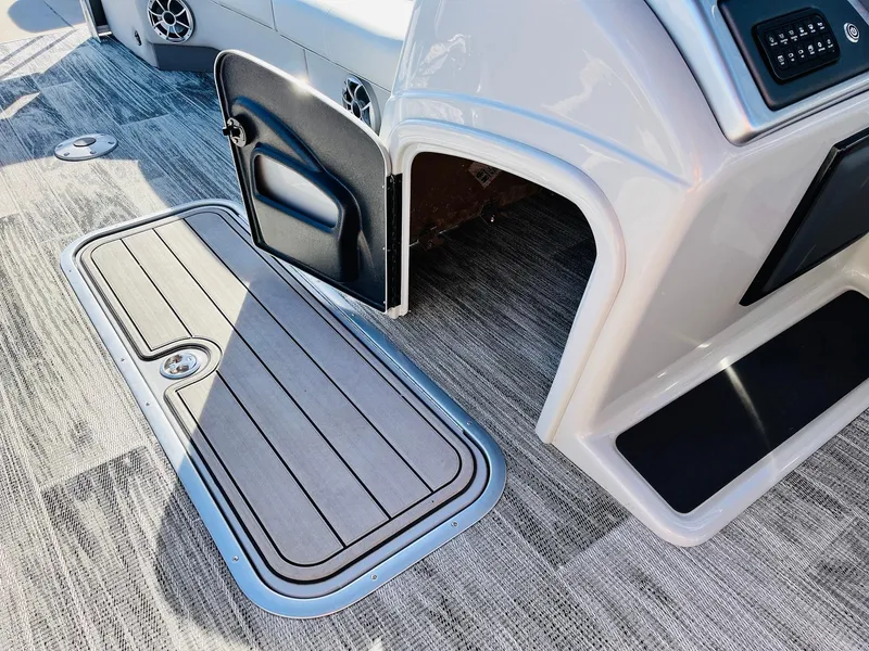 Slide: The Image of 2025 Ranger Reata 223FC boat interior with open storage compartment and sleek flooring. - 33