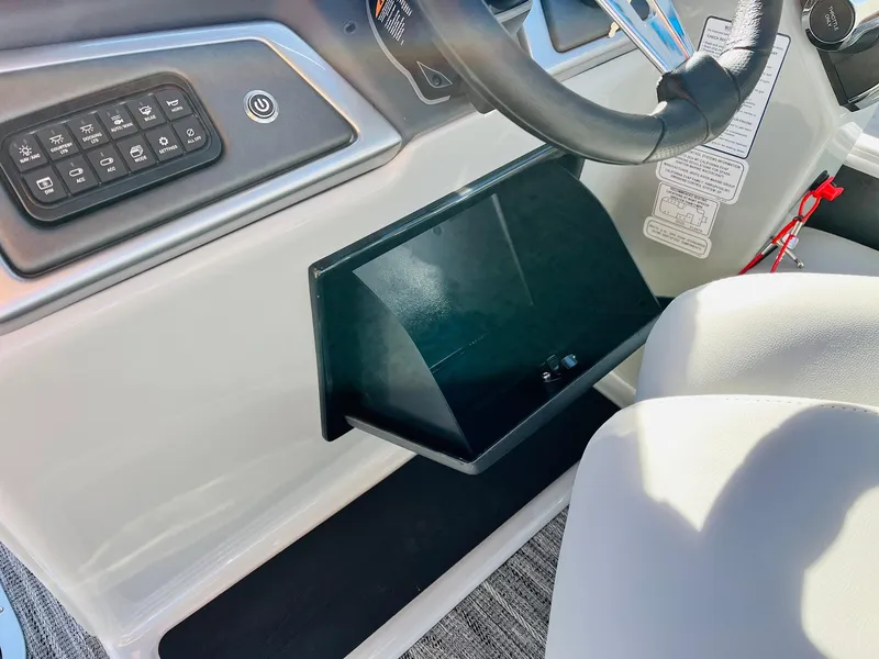 Slide: The Image of 2025 Ranger Reata 223FC boat dashboard with control panel and steering wheel. - 37