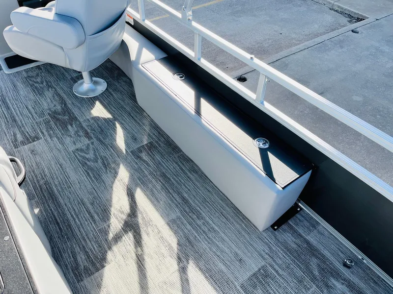 Slide: The Image of 2025 Ranger Reata 223FC boat interior with gray seating and flooring. - 38