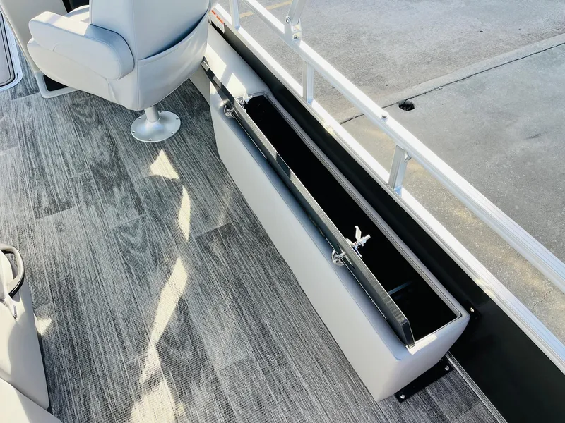 Slide: The Image of 2025 Ranger Reata 223FC boat interior with open storage compartment and seating. - 39