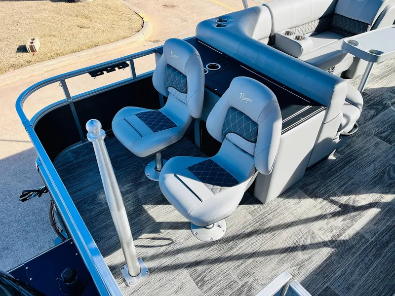 Slide: The Image of 2025 Ranger Reata 223FC boat interior with gray seating and modern design. - 41