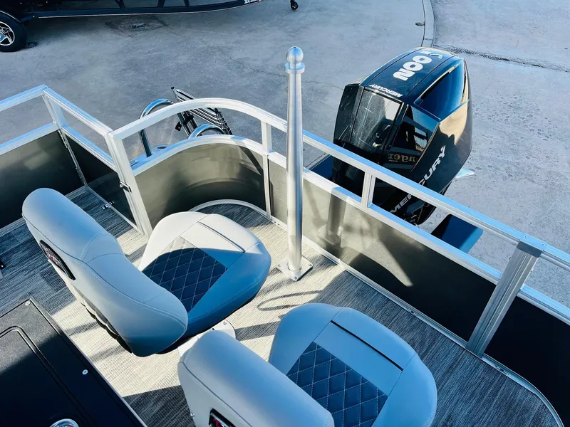Slide: The Image of 2025 Ranger Reata 223FC boat interior with dual seats and Mercury outboard motor. - 43