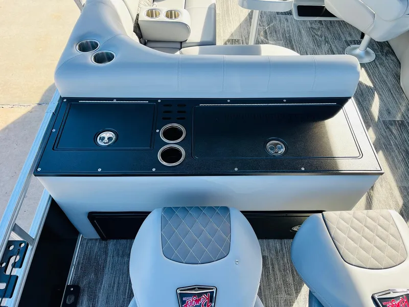 Slide: The Image of 2025 Ranger Reata 223FC boat interior with seating and cup holders. - 44