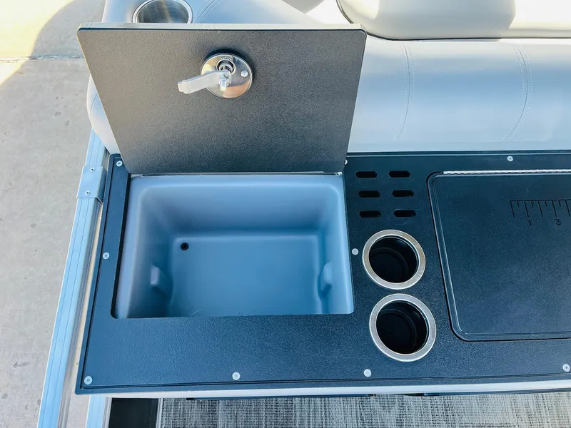 Slide: The Image of 2025 Ranger Reata 223FC boat console with storage compartment and cup holders. - 45