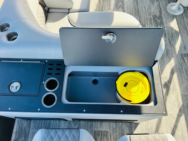 Slide: The Image of Interior of 2025 Ranger Reata 223FC boat with open storage compartment and cup holders. - 46