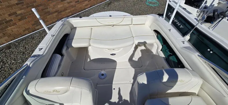 Slide: The Image of 2002 Sea Ray 225 Weekender boat interior with white seating and deck. - 4