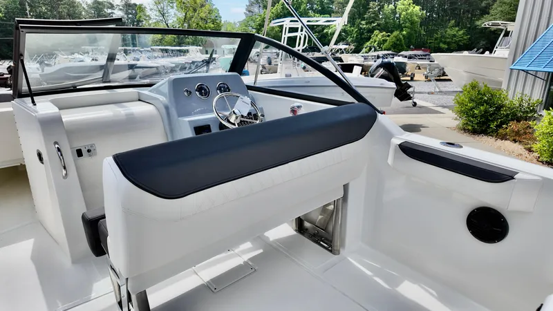 Slide: The Image of 2025 Bayliner Trophy 22 Side Console boat interior with steering wheel and seating. - 11
