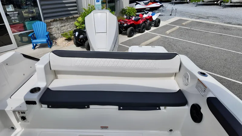 Slide: The Image of 2025 Bayliner Trophy 22 Side Console boat interior with seating and outboard motor. - 12