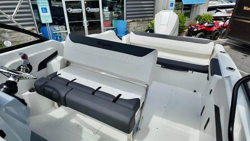Slide: The Image of 2025 Bayliner Trophy 22 Side Console boat interior with seating and console view. - 14