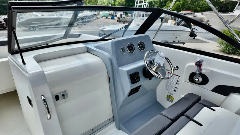 Slide: The Image of 2025 Bayliner Trophy 22 Side Console boat interior with steering wheel and dashboard. - 17