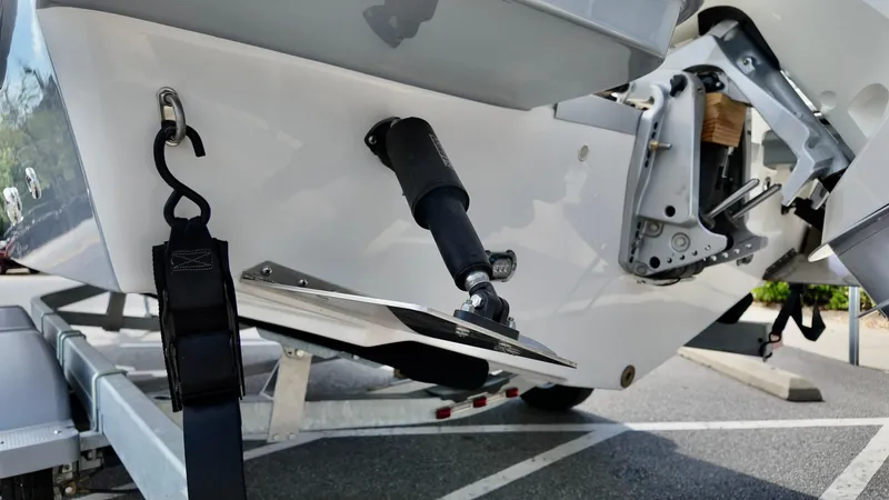 Slide: The Image of 2025 Bayliner Trophy 22 Side Console boat on trailer, showing rear details and components. - 4