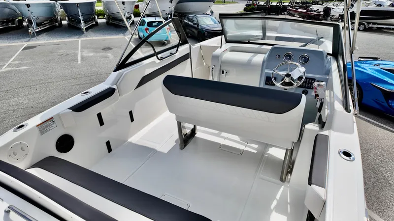 Slide: The Image of 2025 Bayliner Trophy 22 Side Console boat interior with modern seating and dashboard. - 9