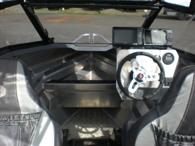 Slide: The Image of 2024 Stabicraft 1550 Fisher boat interior with steering wheel and navigation system. - 6