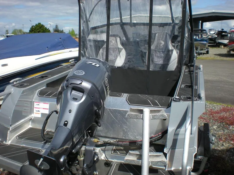Slide: The Image of 2024 Stabicraft 1550 Fisher boat with outboard motor, docked outdoors. - 7