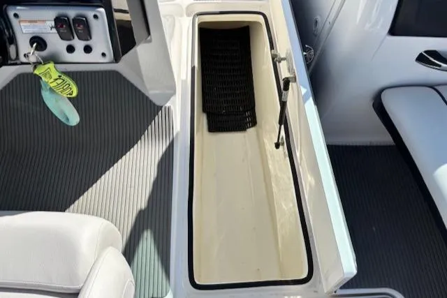 Slide: The Image of 2014 Yamaha AR192 boat interior storage compartment with control panel and seating. - 22