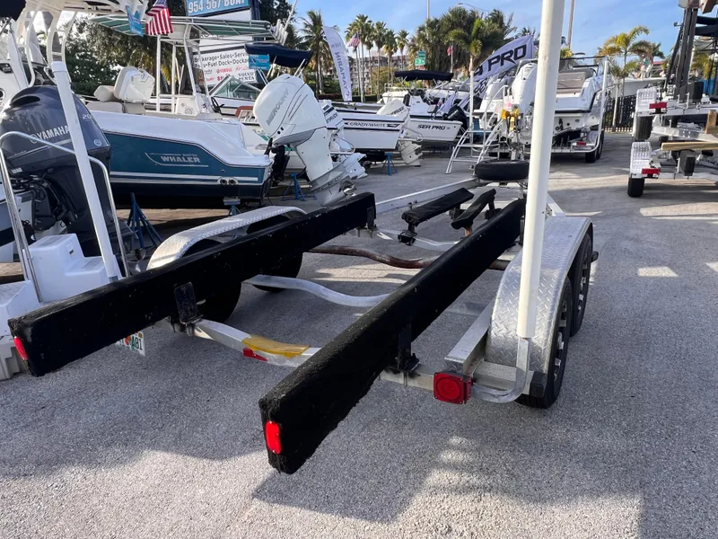 Slide: The Image of 2018 Nextrail 19-21 Tandem Axel trailer in a boatyard setting. - 10