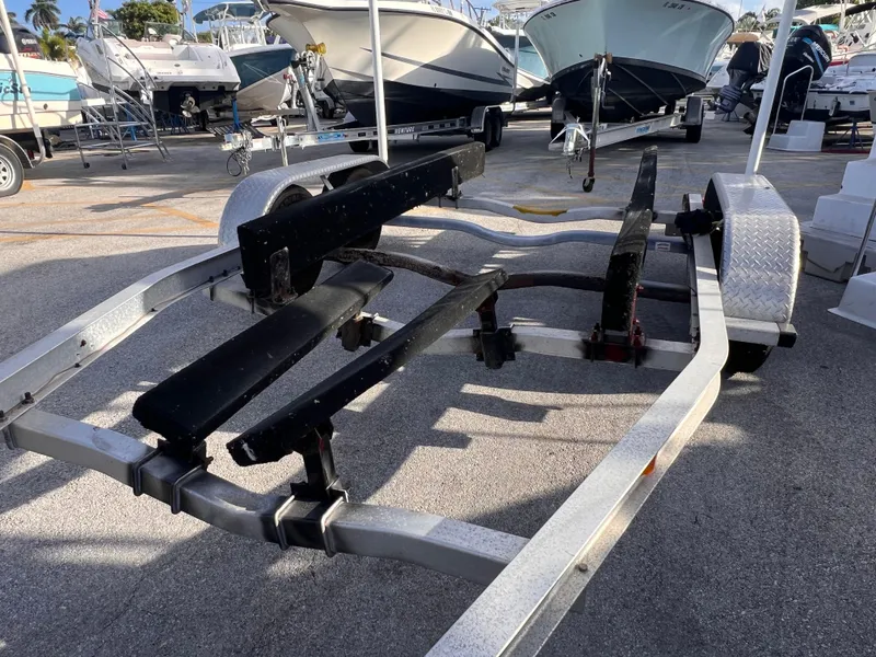 Slide: The Image of 2018 Nextrail 19-21 Tandem Axel trailer in a boatyard, surrounded by boats. - 6