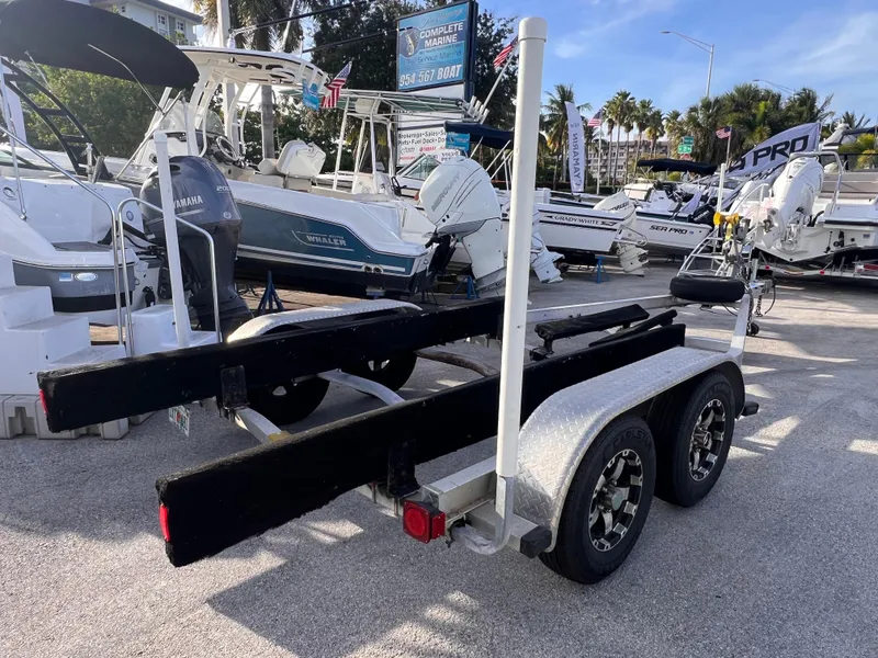 Slide: The Image of 2018 Nextrail 19-21 Tandem Axel trailer in a boat dealership lot. - 9