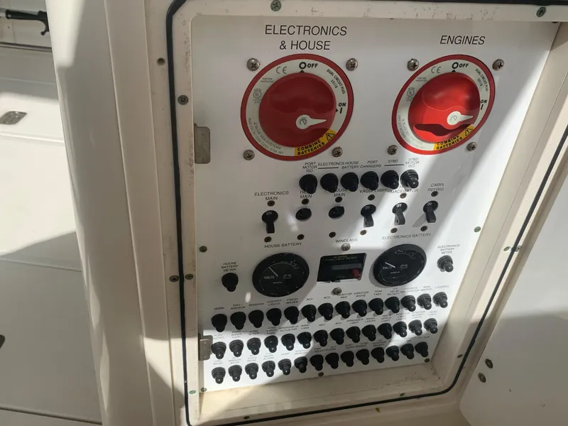 Slide: The Image of Control panel of a 2008 Pursuit 315 OS boat, featuring electronics and engine switches. - 12