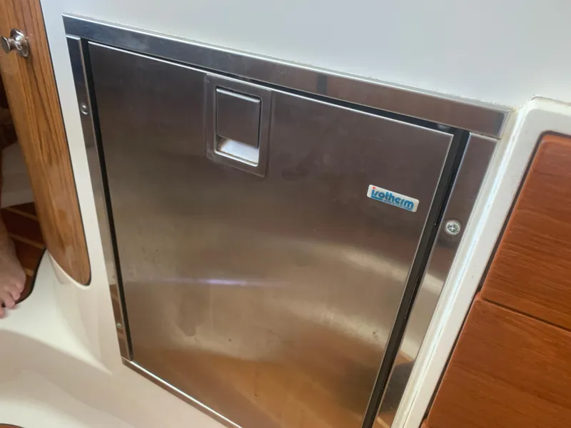 Slide: The Image of Stainless steel door on a 2008 Pursuit 315 OS boat interior. - 22