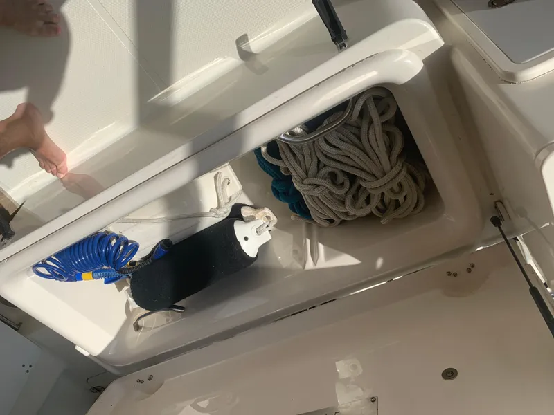 Slide: The Image of Storage compartment on a 2008 Pursuit 315 OS boat with ropes and accessories. - 25