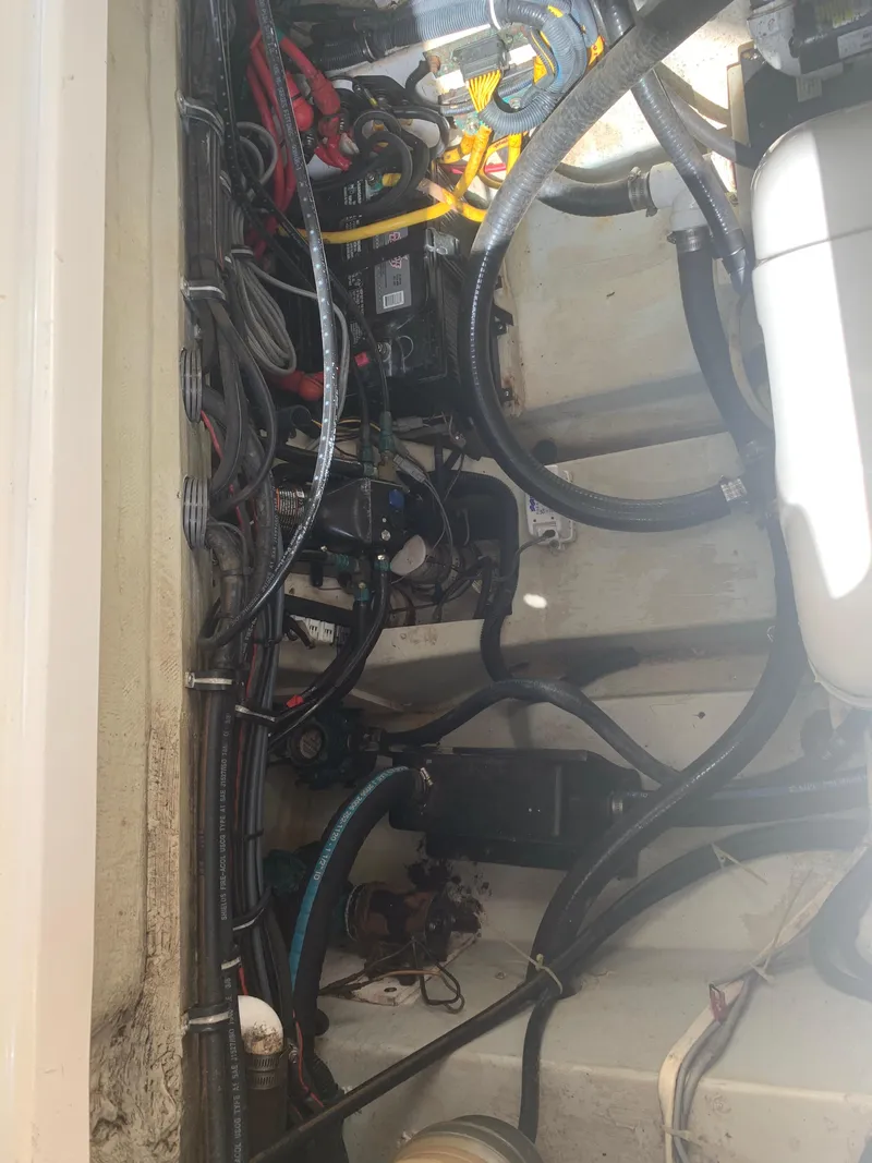Slide: The Image of Engine compartment of a 2008 Pursuit 315 OS boat, showing wiring and components. - 26