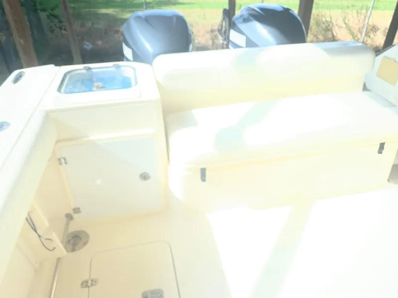 Slide: The Image of 2008 Pursuit 315 OS boat interior with seating and storage compartments. - 28