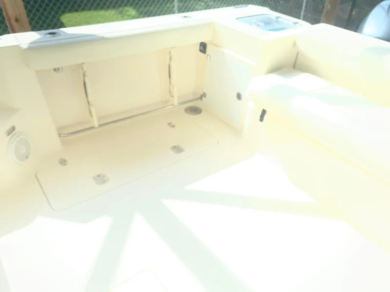 Slide: The Image of 2008 Pursuit 315 OS boat interior with storage compartments and seating area. - 29