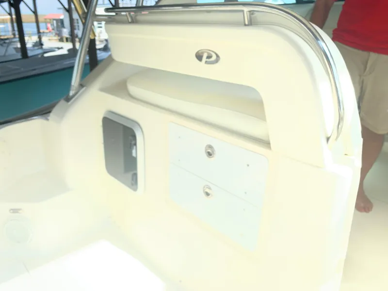 Slide: The Image of 2008 Pursuit 315 OS boat interior with storage compartments and seating. - 30