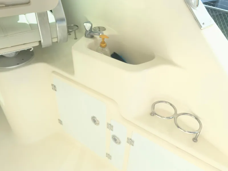 Slide: The Image of Interior view of a 2008 Pursuit 315 OS boat, featuring storage and cup holders. - 31