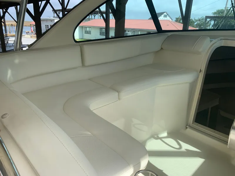Slide: The Image of 2008 Pursuit 315 OS boat interior with white seating and natural light. - 33