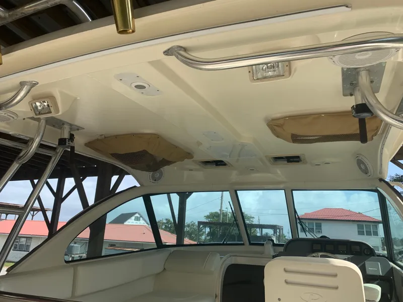 Slide: The Image of 2008 Pursuit 315 OS boat interior with seating and overhead storage compartments. - 36