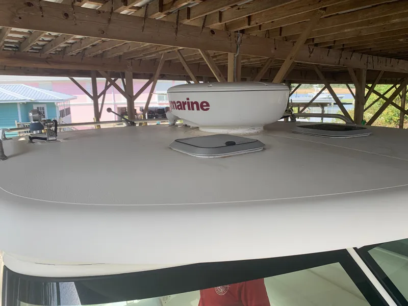 Slide: The Image of 2008 Pursuit 315 OS boat roof with radar dome under wooden shelter. - 39