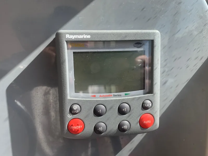 Slide: The Image of Raymarine autopilot control on 2008 Pursuit 315 OS boat dashboard. - 42